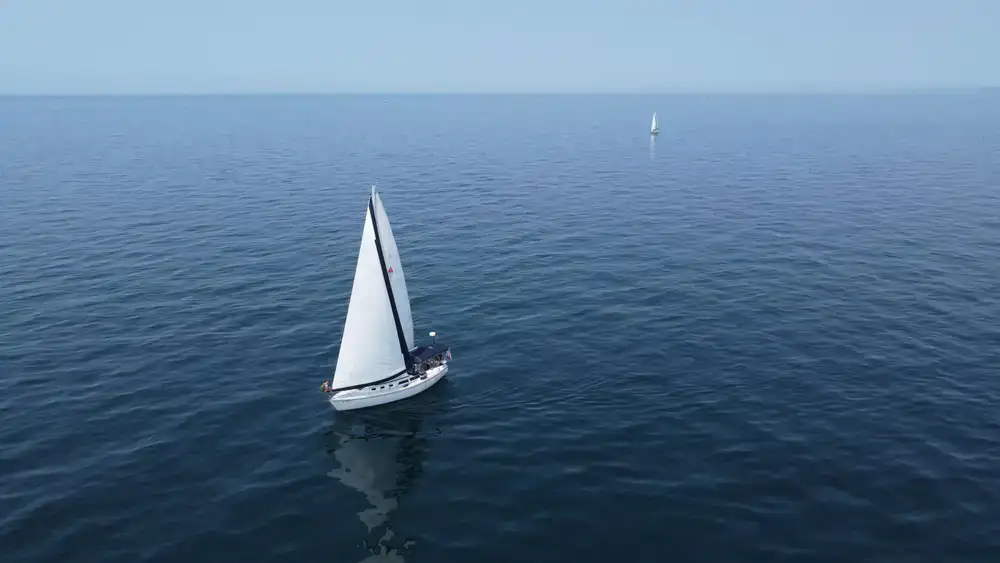 Sailboat sailing smoothly on calm waters