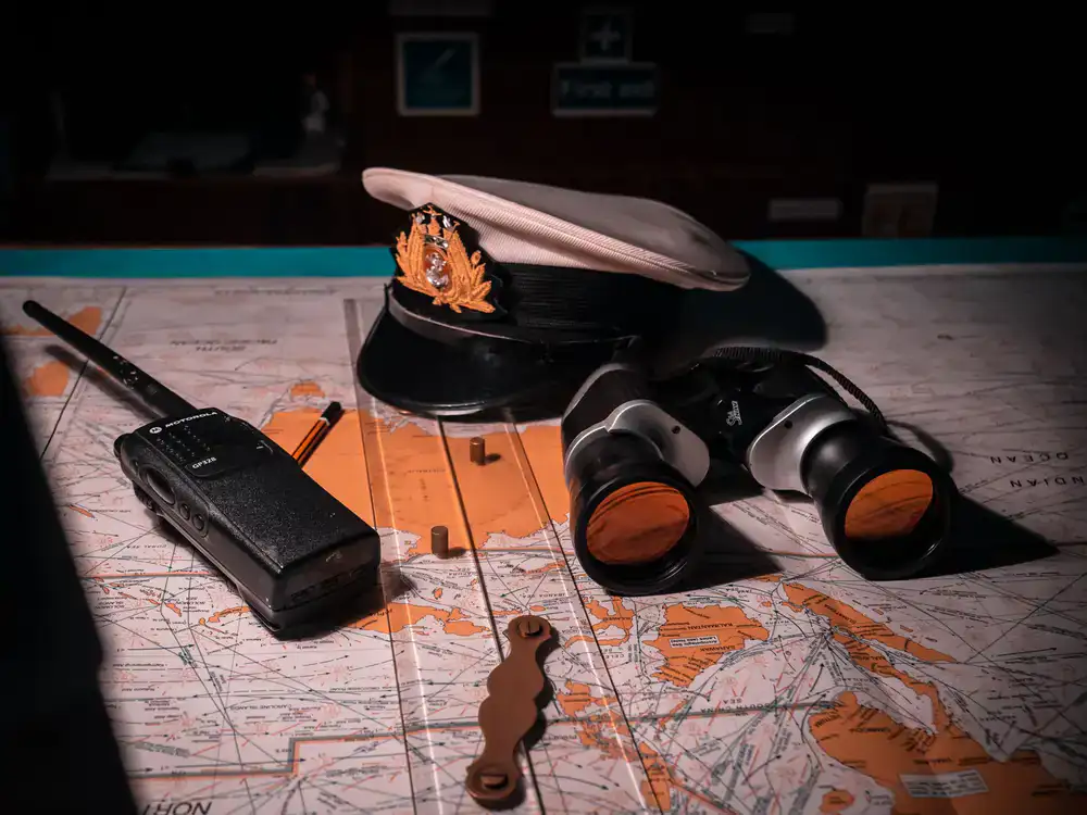 Sailors studying a navigation chart