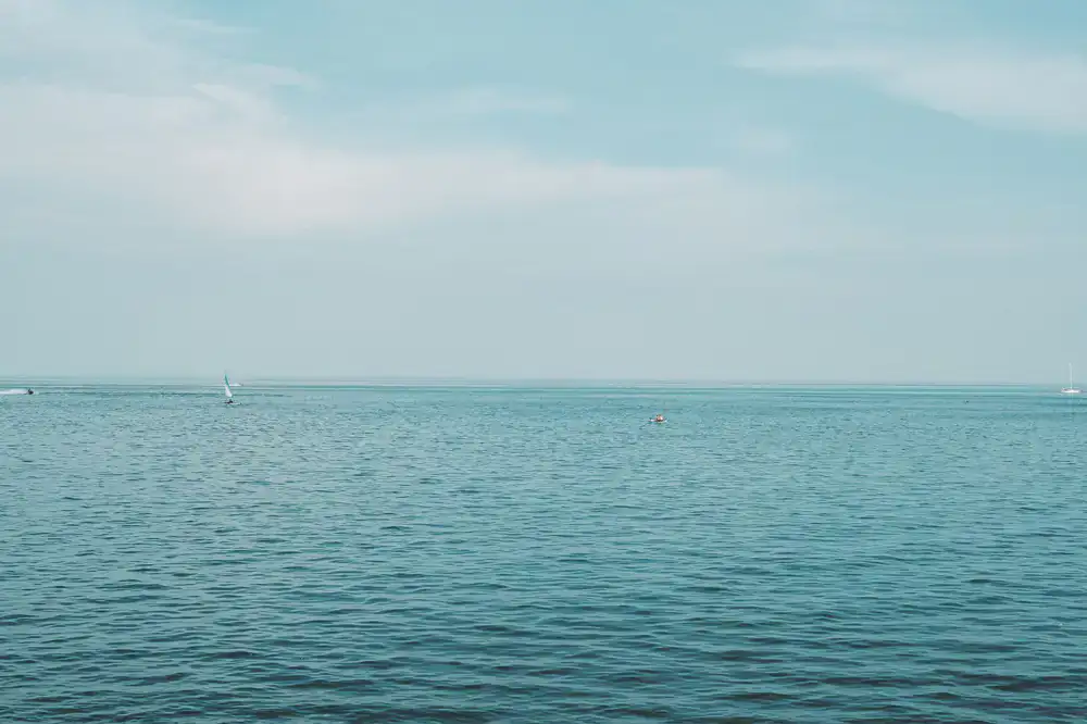 Sailboats navigating clear waters on a bright day