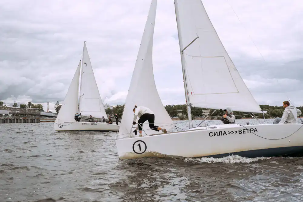 Student steering a sailboat for the first time